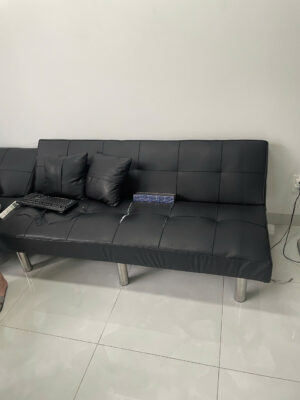 Black sofa with cushions and keyboard